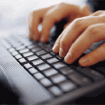 A person typing on a keyboard