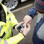 policeman scans fingerprint