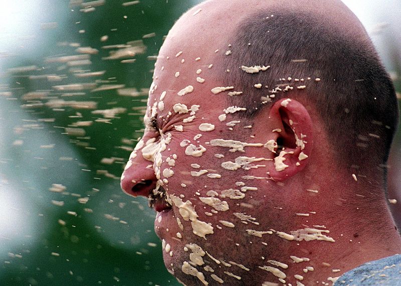 pepper-spray A man squinting as his face is covered in pepper spray.