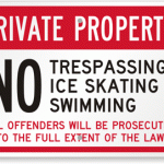 Sign reads: Private property no trespassing, no swimming.