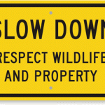 Sign reading: Slow down. Respect wildlife and property